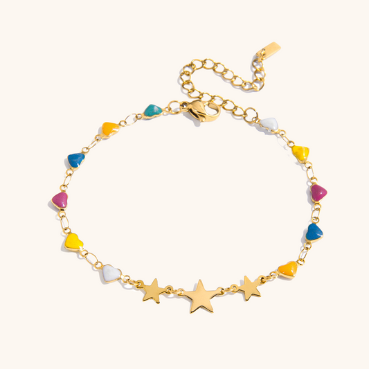 Close-up of colorful star and heart charm bracelet on white background