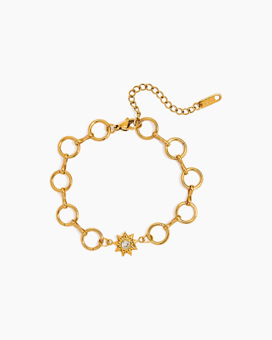 Gold chain bracelet with a star-shaped clasp on a white background