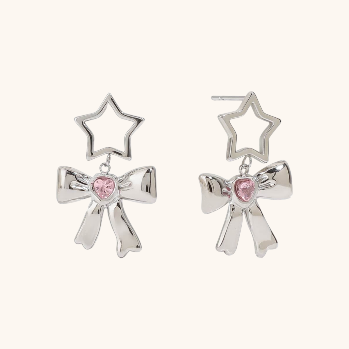 Silver star and bow earrings with pink heart crystal center