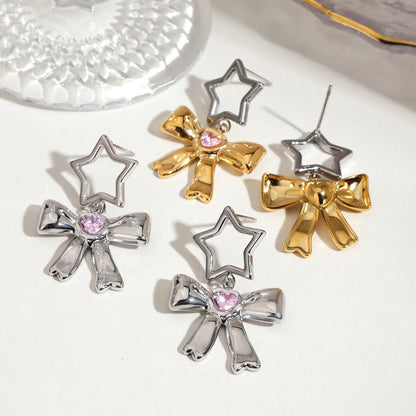 Mixed gold and silver bow drop earrings with pink gemstone hearts