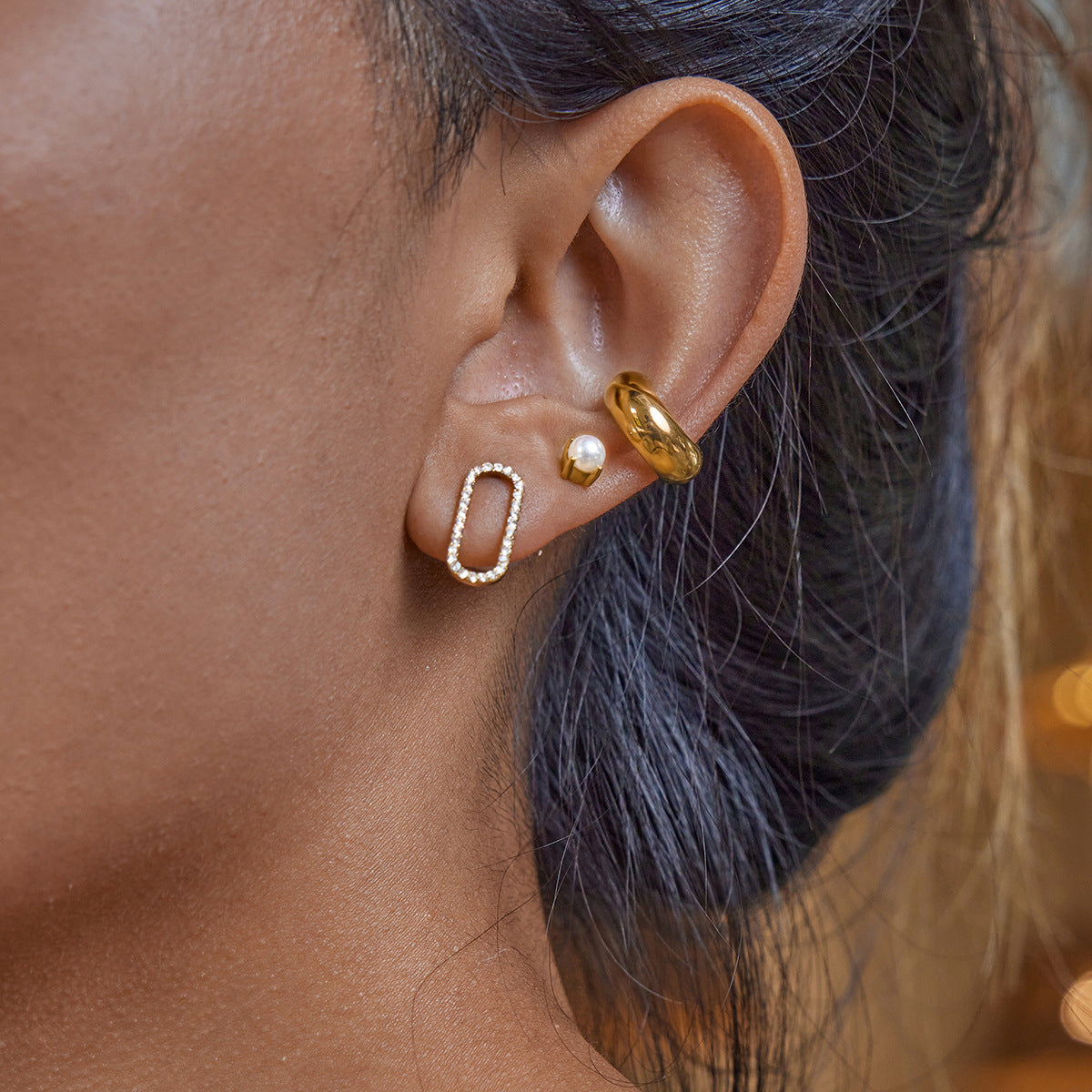 Waterproof gold crystal earrings styled with chunky hoops