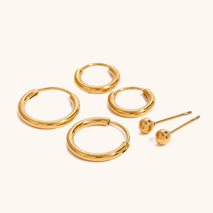 High-shine gold hoop earrings in various sizes with stud earrings, modern chic set