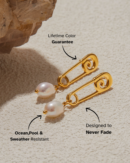 Gold earrings with pearl drops on a textured beige surface, featuring text about color guarantee and weather resistance.