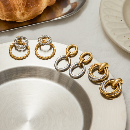 close-up of silver and gold twisted hoop earrings 