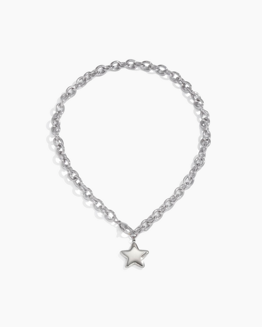 Silver chain bracelet with a star charm on a white background