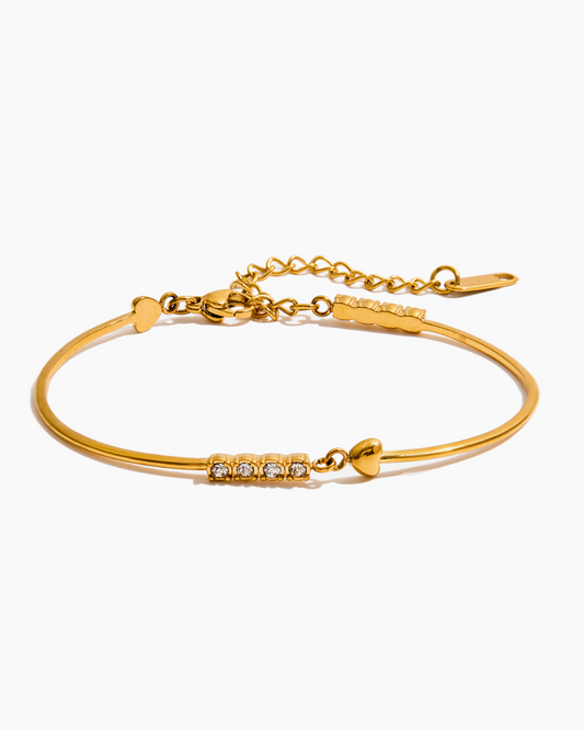Gold bracelet with diamond accents on a white background