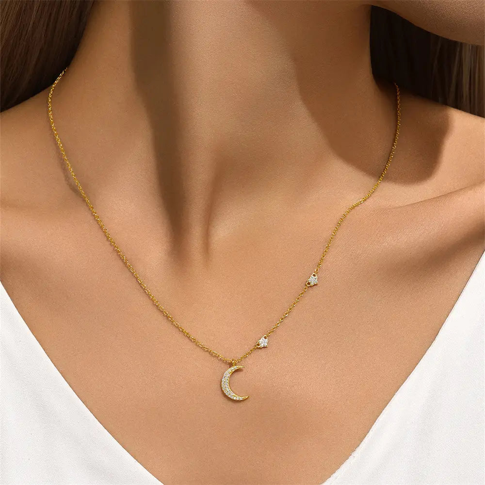 Model wearing a gold crescent moon necklace with sparkling star details for an elegant touch.