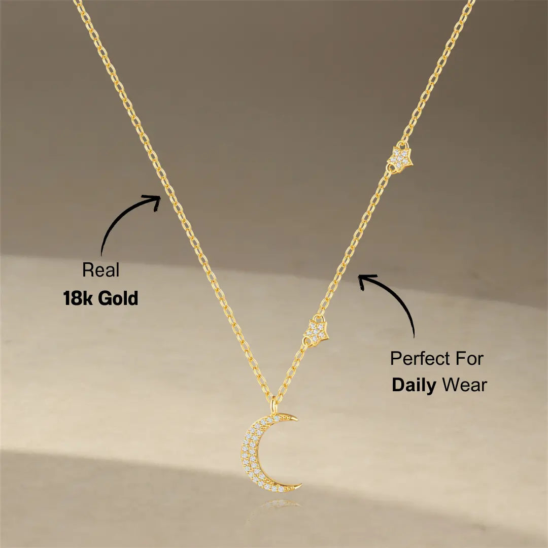 A detailed shot of the sterling silver crescent moon necklace with a star accent, featuring sparkling zirconia stones.