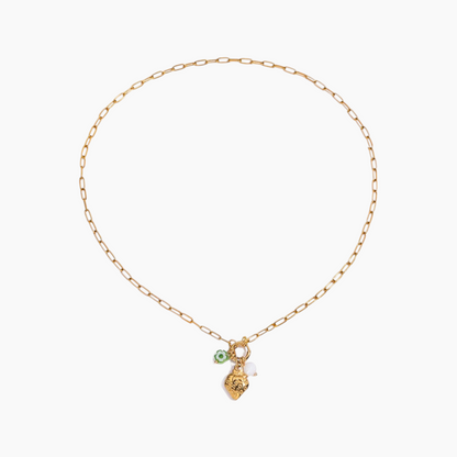 Gold necklace with a small green pendant on a white background