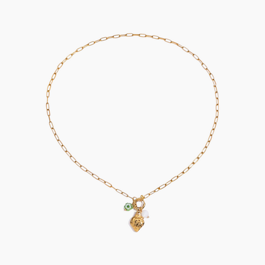 Gold necklace with a small green pendant on a white background