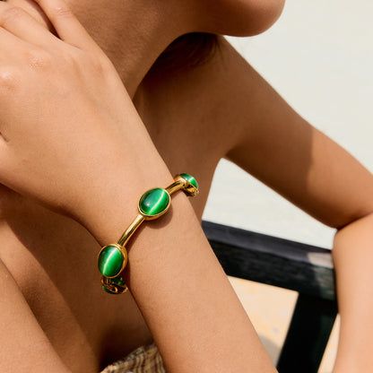 Modern open cuff bracelet styled with a sleeveless summer outfit