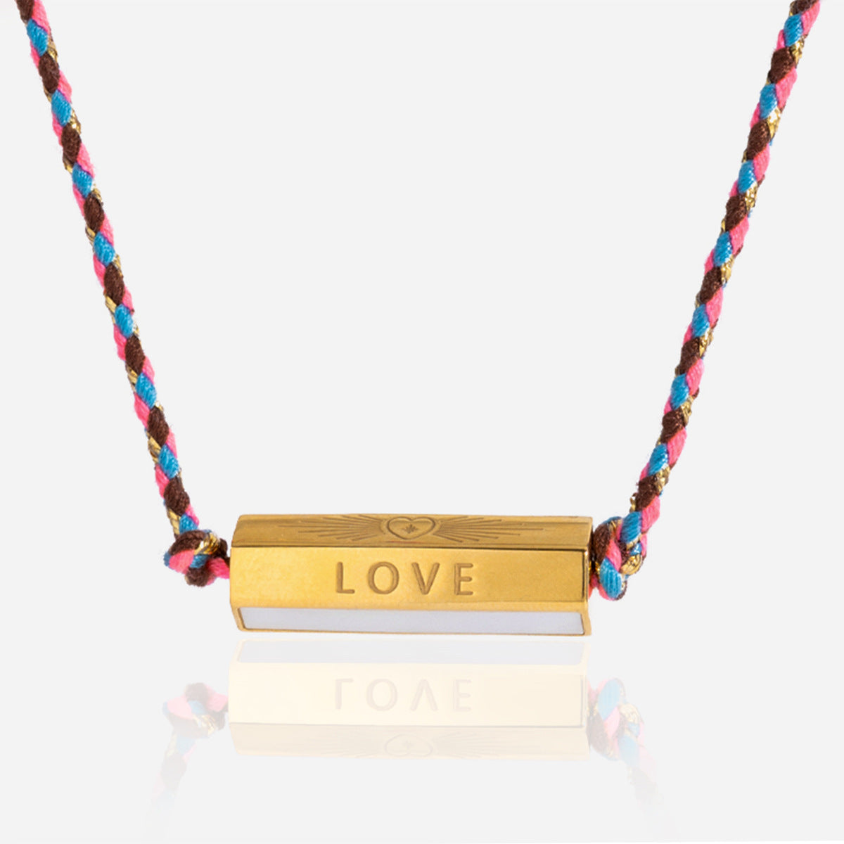 Detailed view of gold bar LOVE pendant with heart engraving