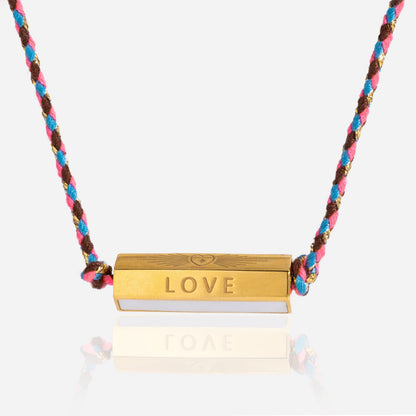 Detailed view of gold bar LOVE pendant with heart engraving