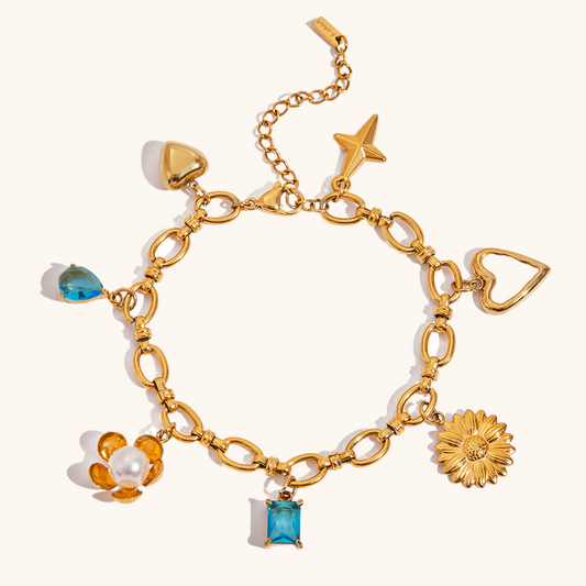 Close-up of waterproof gold bracelet with daisy, heart and star pendants