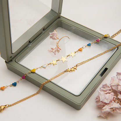 Star charm bracelet styled in boho summer outfit outdoors