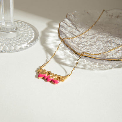 Close-up of romantic gold necklace with angel wing LOVE pendant