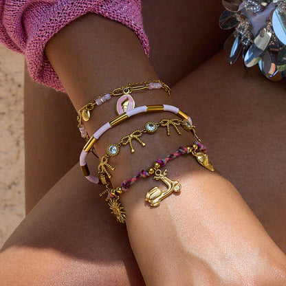 Model wearing colorful scooter charm bracelet with gold pendants