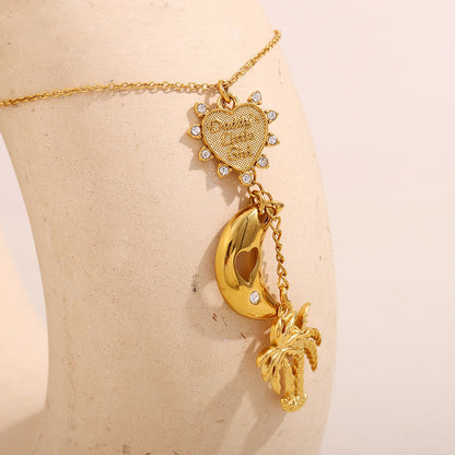 close-up of heart sun charm and hollow moon on gold necklace for women