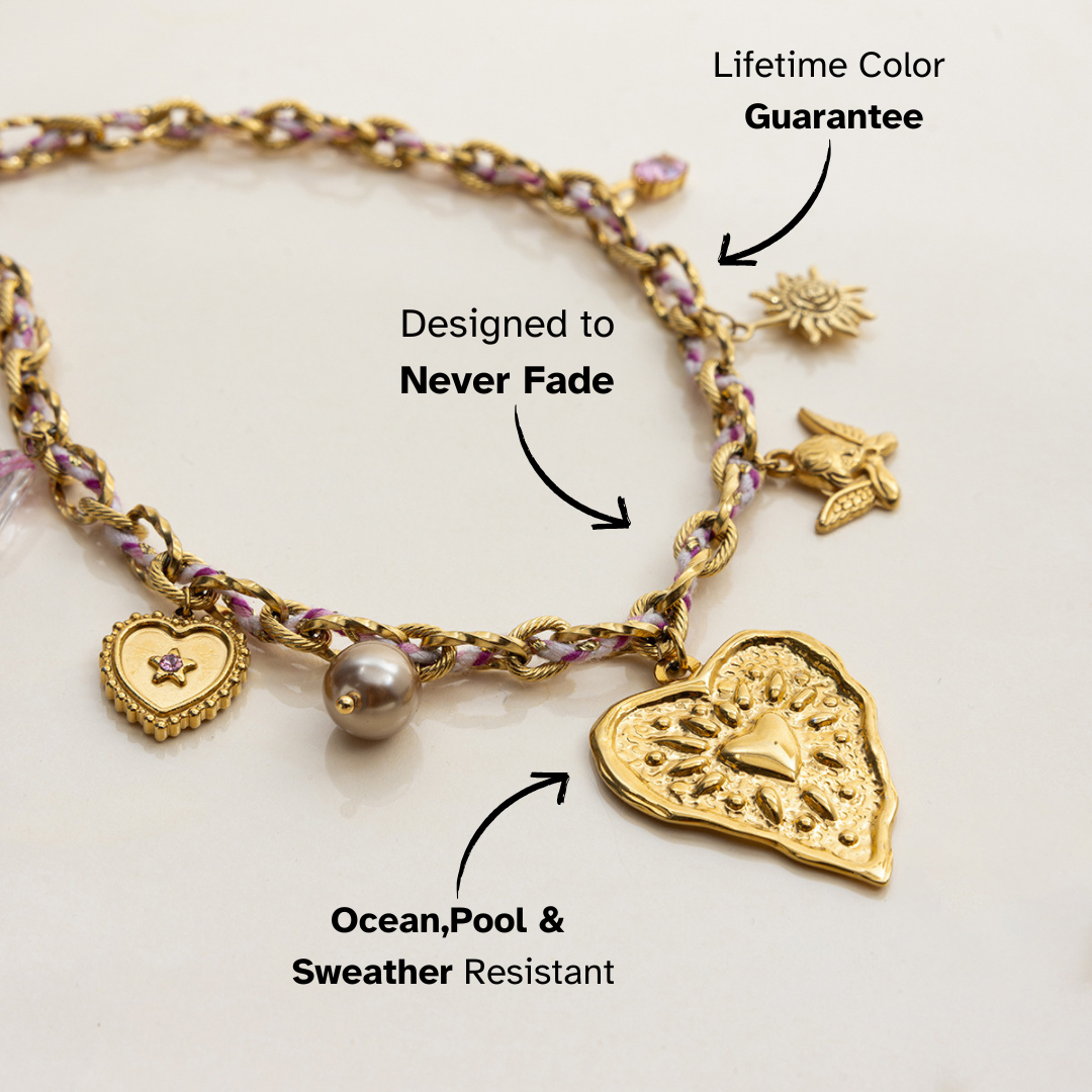 Layered gold choker with sun, bird, and heart pendants