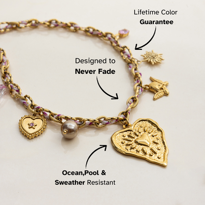 Layered gold choker with sun, bird, and heart pendants