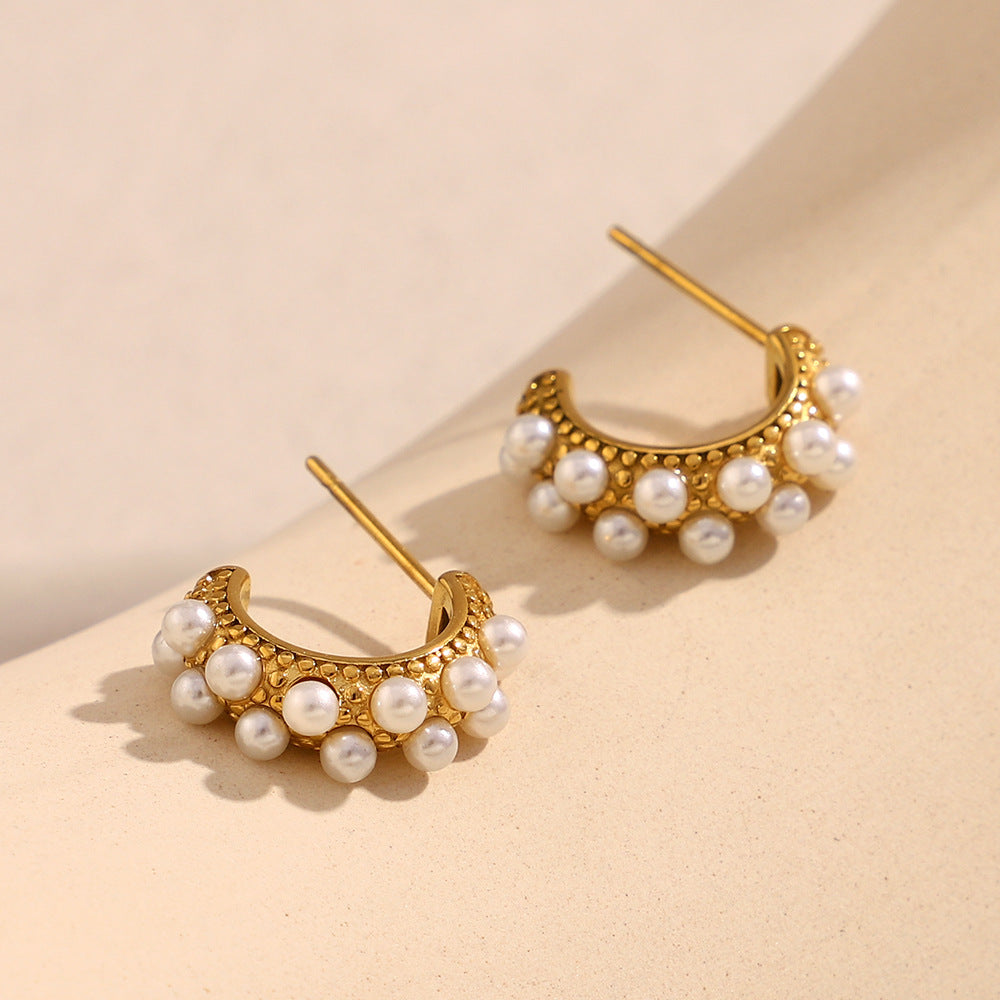Side view of round pearl hoop earrings in sunlit beige setting