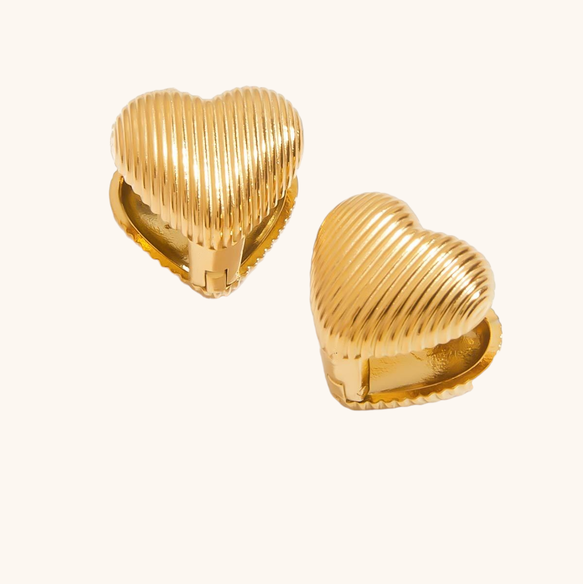 Close-up of gold heart-shaped clip-on earrings with ribbed texture