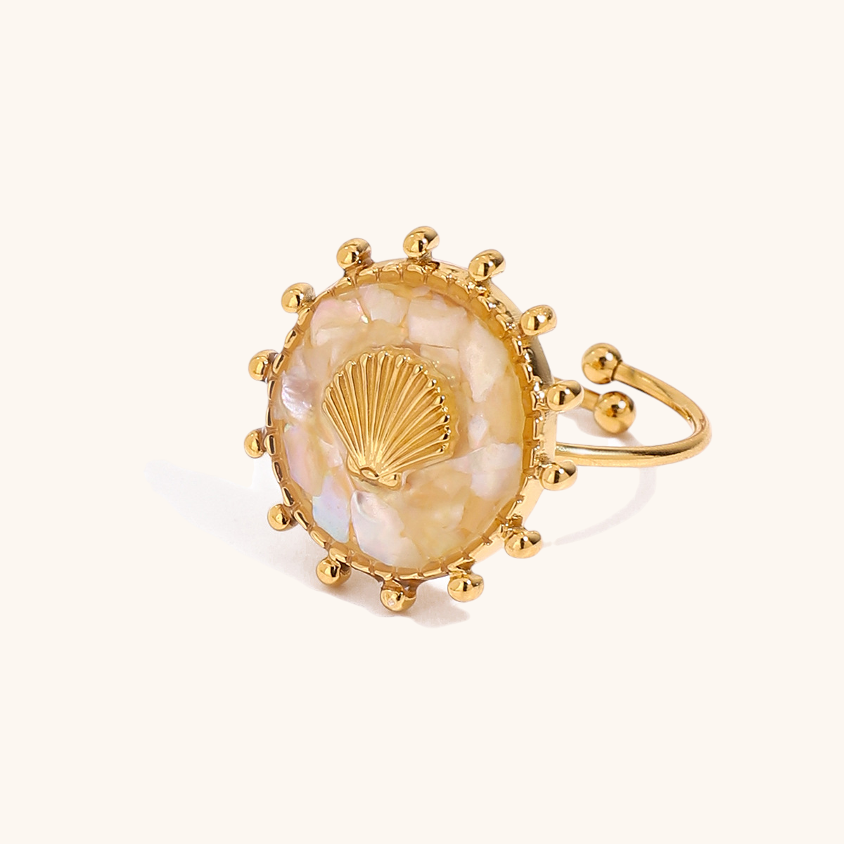 Boho summer style open ring with scallop shell design and pearl shimmer, worn on beachside patio