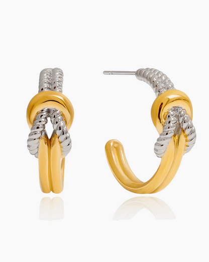 Gold and silver hoop earrings on a white background