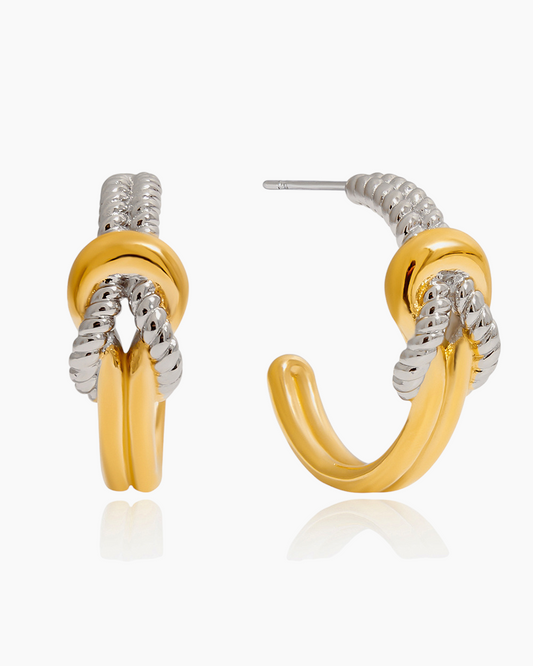 Gold and silver hoop earrings on a white background