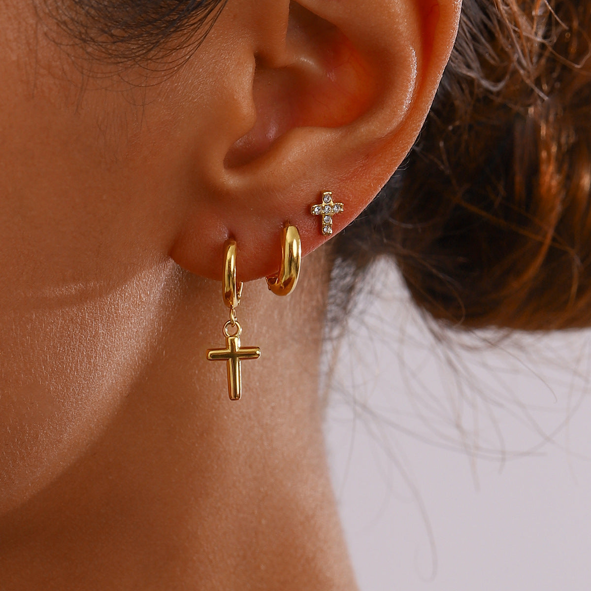 Small cross stud earrings with cubic zirconia sparkle, on display card