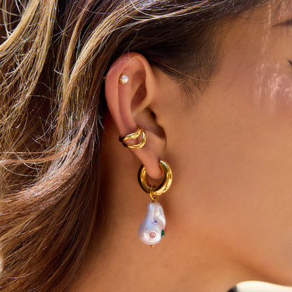 Stylish ear shot with gold hoop and whimsical pearl drop