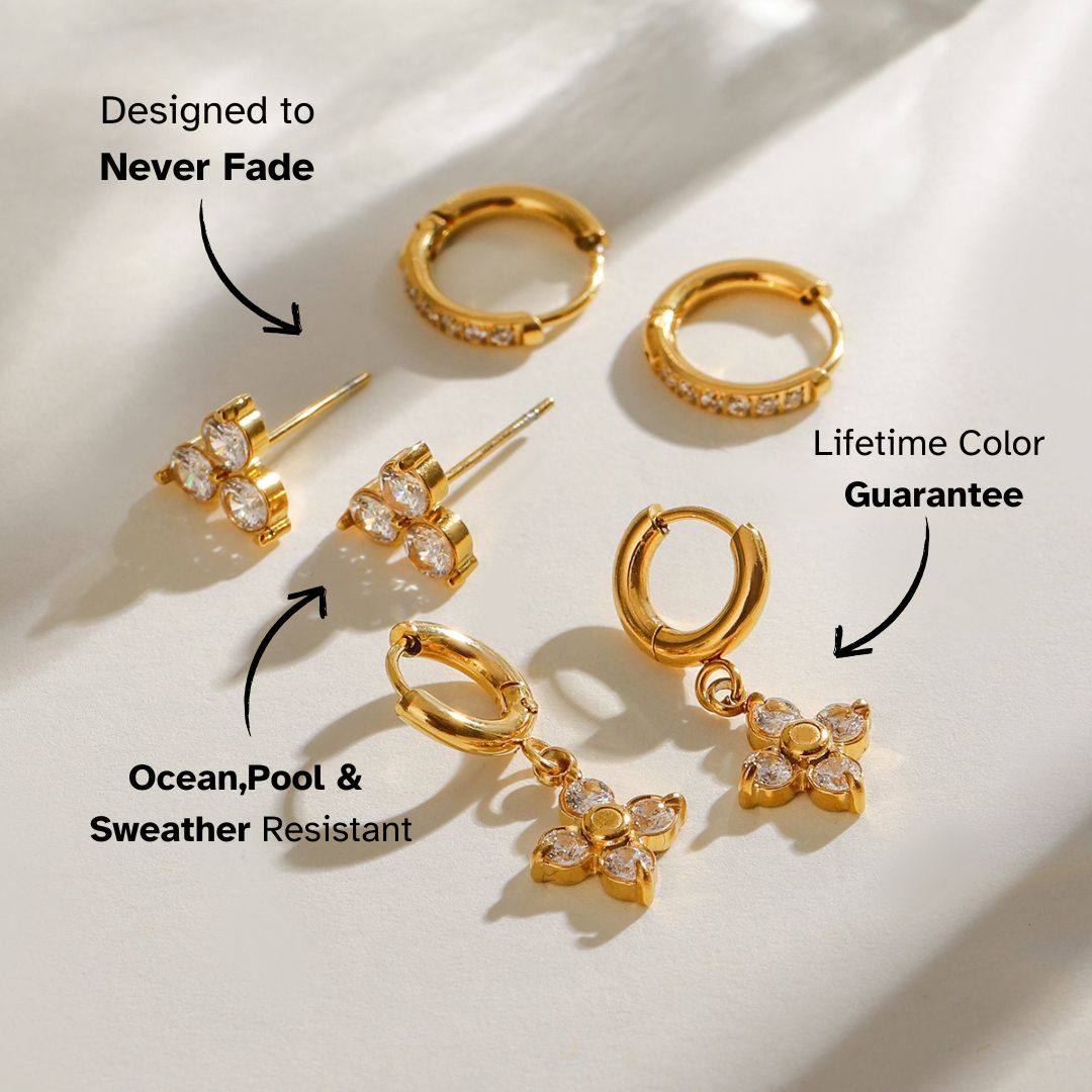 Close-up of elegant gold studs with three clear cubic zirconia stones