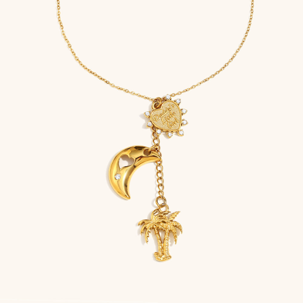 gold necklace with palm tree and crescent moon charm, engraved heart pendant