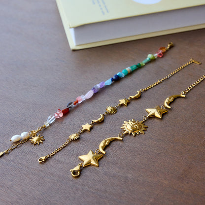  Rainbow gemstone bracelet with pearls and sun charm displayed with summer accessories