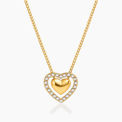 Gold heart-shaped necklace with embedded stones on a white background