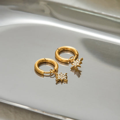 celestial-inspired star earrings on silver tray jewelry detail