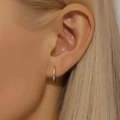 Two-Tone Huggie Hoops for Everyday Wear - A mix of silver and gold, these earrings are your new go-to for versatile styling with a minimalist edge.