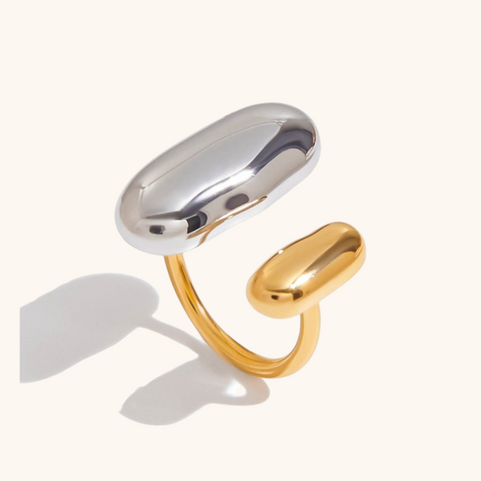 Modern silver and gold open ring on white background, perfect for layering or solo wear