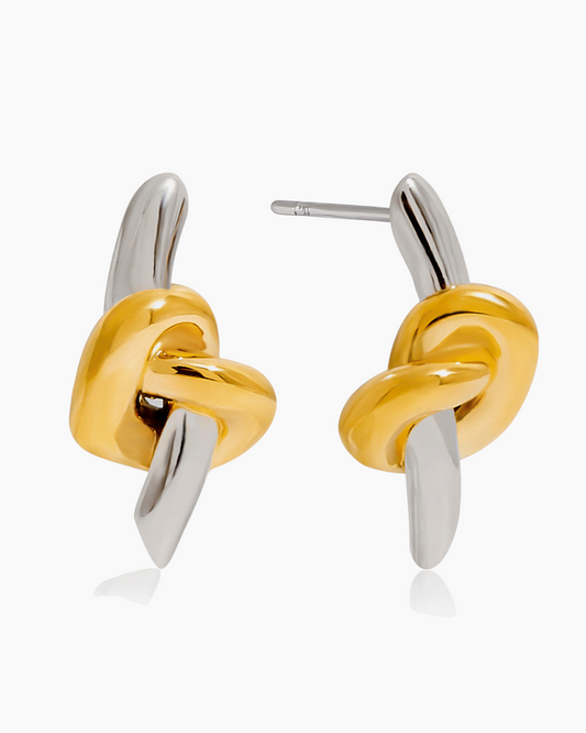 Gold and silver knot-shaped earrings on a white background