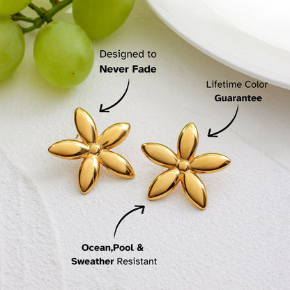 Statement flower studs styled on fruit plate with bright summer colors