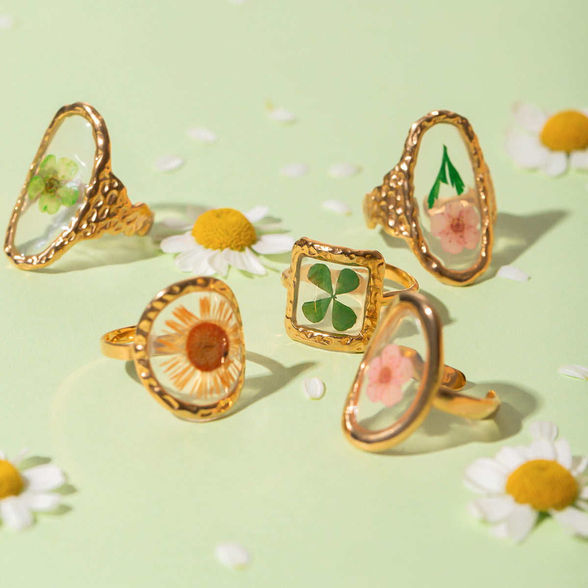 Soft-focus image of vintage-style pink flower ring with polished resin top