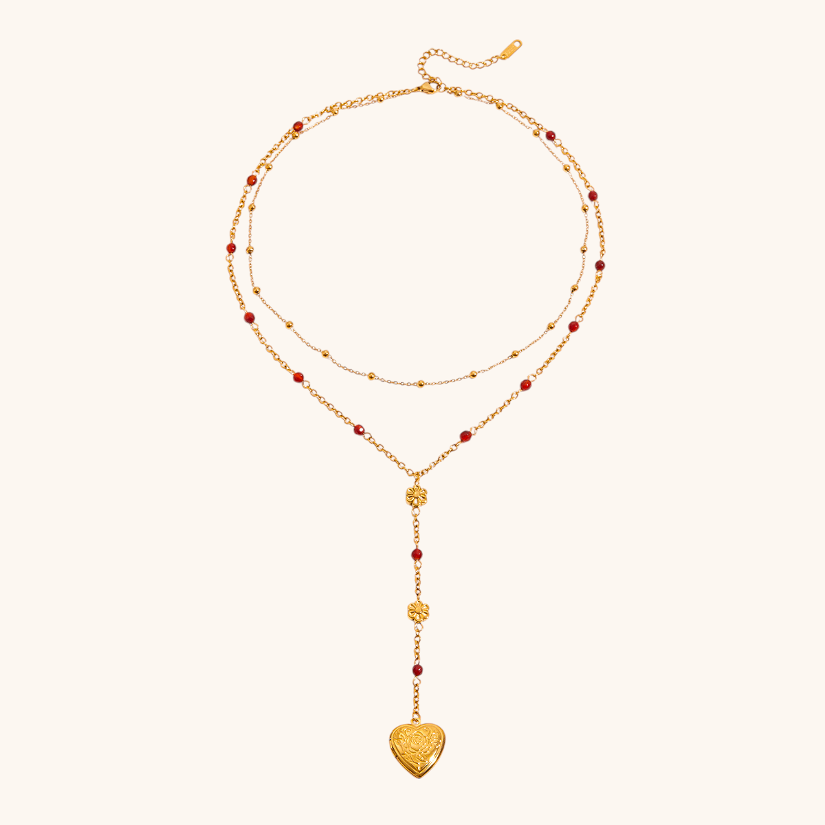 Close-up of gold heart locket necklace with floral charm