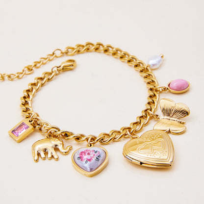 Vintage-style locket charm bracelet with elephant and pearl accents