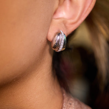 Side-by-side gold and silver textured stud earrings with cubic zirconia