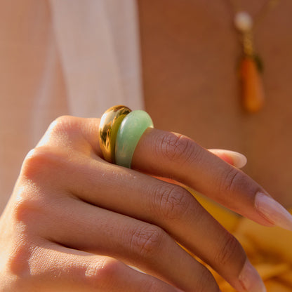 Model wearing thick green ring with waterproof jewelry set