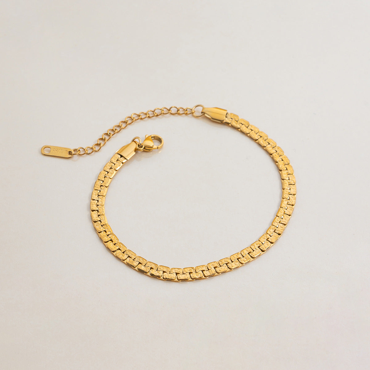 Flat lay of classic gold chain bracelet with adjustable clasp