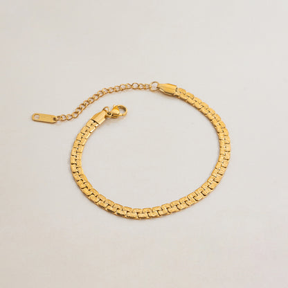 Flat lay of classic gold chain bracelet with adjustable clasp
