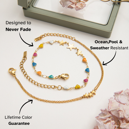 Gold bracelet with star charms photographed near dried flowers