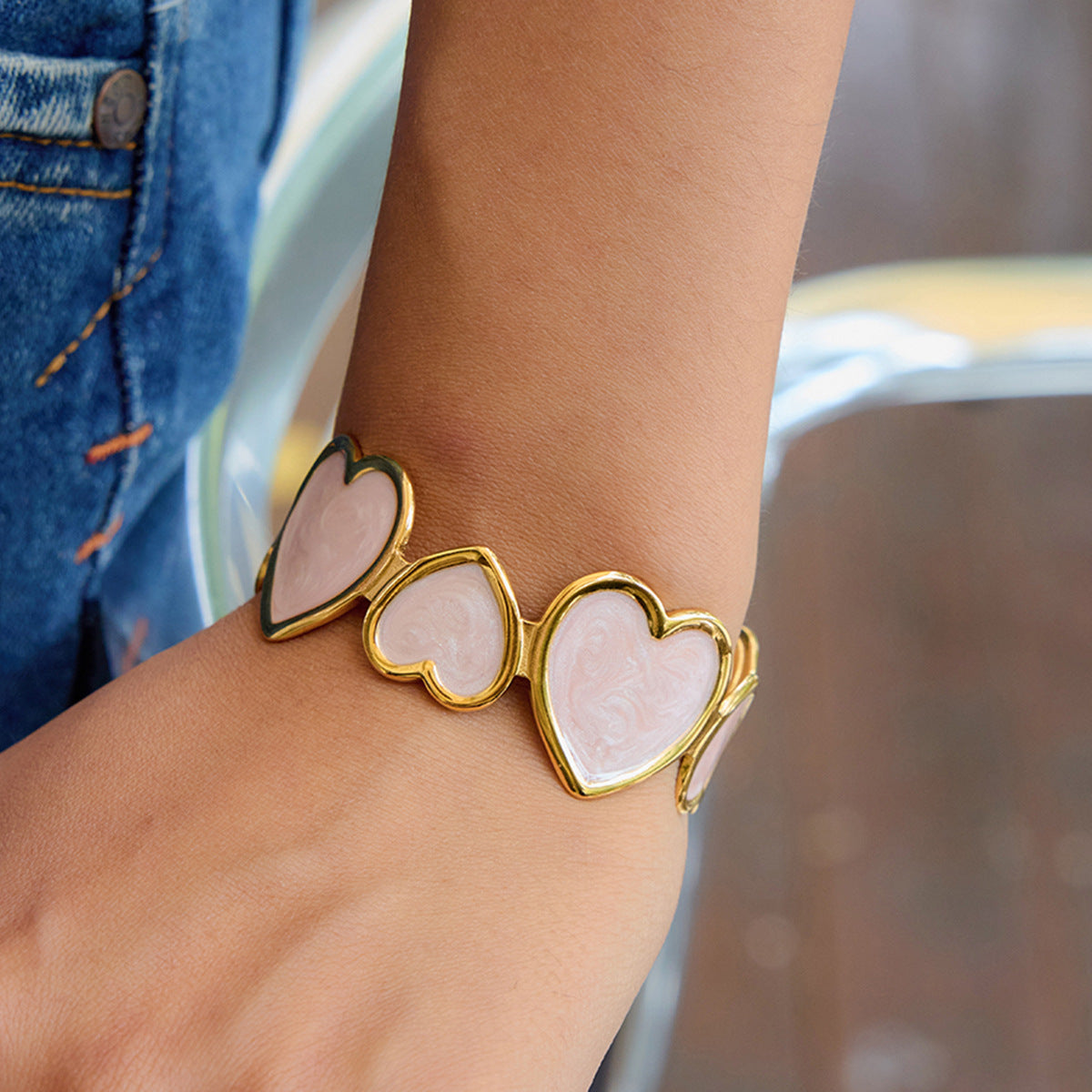 model wearing pink heart cuff bracelet with gold finish