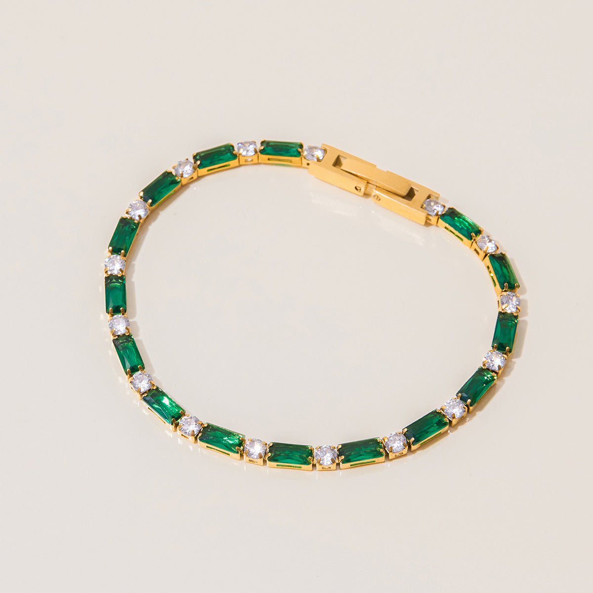 Bracelet layered with gold bangles on a woman's wrist by the pool_MiFJewelry